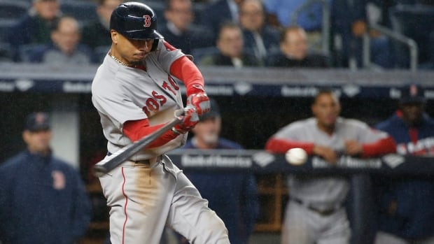 Boston Red Sox Mookie Betts (50) hits an eighth-inning, two-run double against the New York Yankees. red-sox