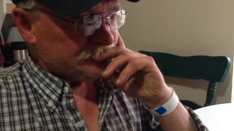 Randy Hilliard sits at his kitchen table, hospital bracelet still on his wrist, after four days lost in the woods. Randy Hilliard
