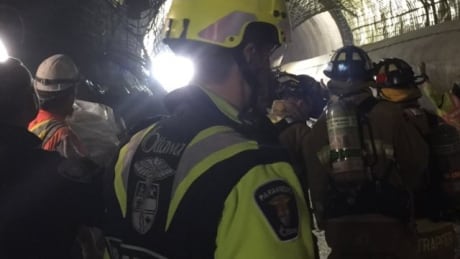 Emergency crews walk inside a light rail tunnel near the University of Ottawa Thursday afternoon where three workers had to be rescued following an industrial accident. lrt light rail tunnel collapse emergency crews