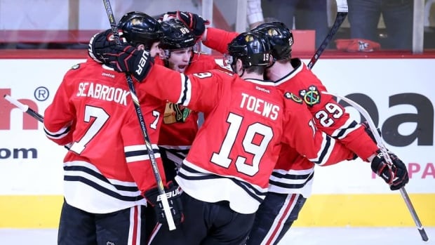 Members of the Chicago Blackhawks celebrate the team’s first goal against the Los Angeles Kings Saturday night in Game 5.