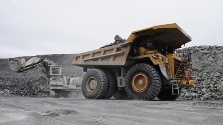 Gold miners work in the open pit mine at Agnico-Eagle's Meadowbank site in 2011. The mine is situated 75 km north of Baker Lake. mi-meadowbank-truck-cp01162884