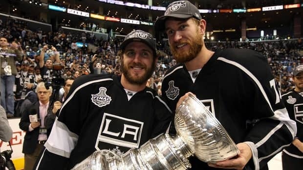 Former Philadelphia Flyers Mike Richards, left, and Jeff Carter pose with the Stanley Cup after their Los Angeles Kings defeated the New Jersey Devils in the finals on Monday. Many NHL players took to Twitter to comment on the game, including a fellow former Flyers forward Joffrey Lupul.