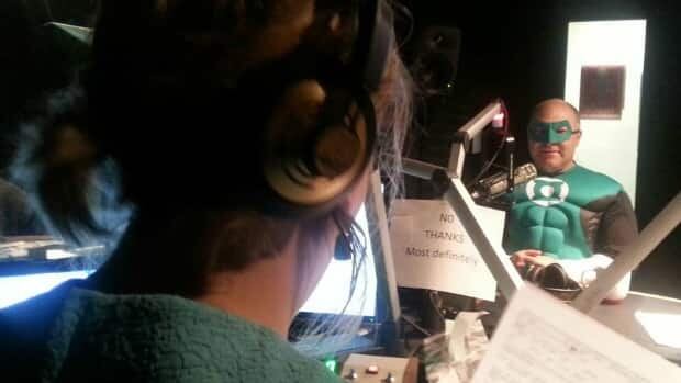 Pat Thompson, owner of 8th Street Books & Comics, joins host of Saskatoon Morning Leisha Grebinski in studio on Thursday dressed as the Green Lantern.