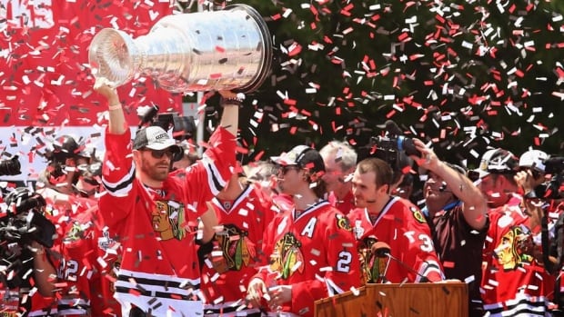 Members of the Chicago Blackhawks celebrate their Stanley Cup win over the Boston Bruins at a rally in Grant Park on Friday in Chicago.