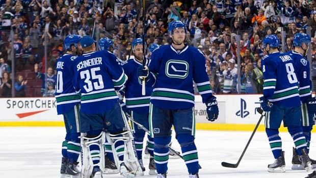 Vancouver Canucks players celebrate their second consecutive Presidents’ Trophy honour with their fans Saturday night at Rogers Arena.