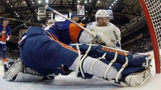 Nazem Kadri, top, of the Toronto Maple Leafs scores his third goal of the game at 14:12 of the second period against New York Islanders goalie Evgeni Nabokov at the Nassau Veterans Memorial Coliseum on Thursday in Uniondale, N.Y.