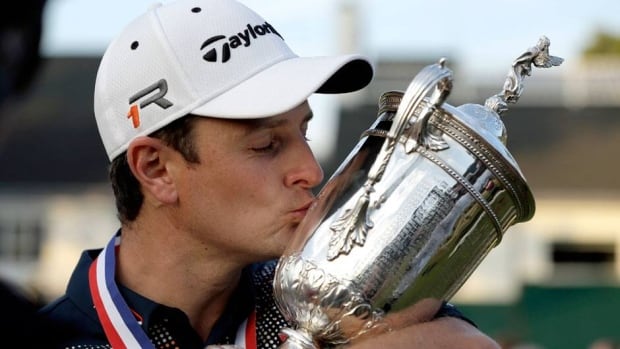 Justin Rose, of England, kisses the trophy after winning the U.S. Open at Merion Golf Club on Sunday in Ardmore, Pa.