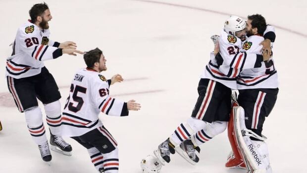 Members of the Chicago Blackhawks react to winning the Stanley Cup after defending the Boston Bruins in Game 6 Monday night.