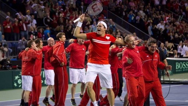 Canada's Milos Raonic, front, celebrates an historic Davis Cup quarter-final win against Italy's Andreas Seppi Sunday in Vancouver. The Canadians will now make their first-ever semifinal appearance.