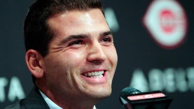 Joey Votto smiles during a news conference announcing his 12-year contract with the Cincinnati Reds on Wednesday. Baseball fans took to Twitter and Facebook to weigh in on the mammoth deal.