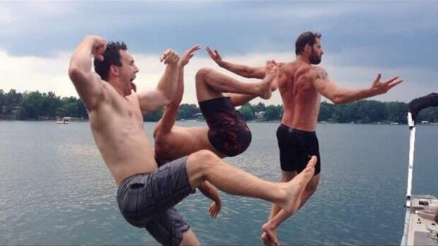 An action shot of Vancouver Canucks forward Ryan Kesler, right, jumping into a lake with friends this summer during the NHL off-season. Kesler is just one of dozens of players in the NHL's new Pacific Division keeping himself busy this summer.