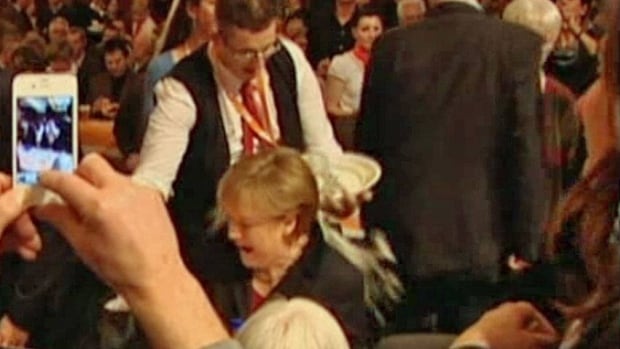 Prost! Merkel gamely weathers a beer spill | CBC News