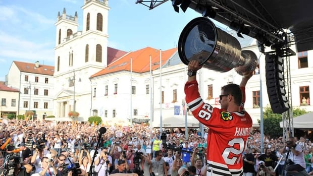 Michal Handzus of the Chicago Blackhawks holds the Stanley Cup as he arrives at main square in Banska Bystrica, Slovakia on August 8 during a tour of his hometown. The Hawks players have taken turns spending a day with the Cup this summer.