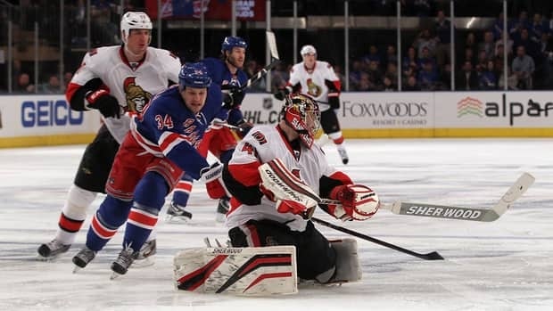 Senators Goalie Craig Anderson (41) skates far out from the net to clear the puck against New York Rangers centre John Mitchell (34) during Game 1 on Thursday.