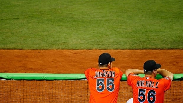 Josh Johnson and Mark Buehrle look on during a game against the New York Yankees at Marlins Park last season. Reports say the pitchers are on their way to Toronto.