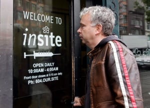 Mark Townsend, manager of the Portland Hotel Society, enters Insite