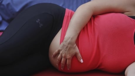 Pregnant women's risk of developing pre-eclampsia, a potentially life-threatening disorder, went up by as much as 30 per cent when their exposure to traffic-related air pollution was increased, an Australian researcher has found. Here, a pregnant woman touches her stomach while doing yoga on the morning of the summer solstice in New York's Times Square on June 20, 2012. hi-pregnancyrtr33x32-8col