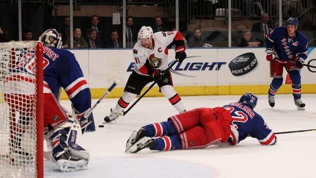 Daniel Alfredsson (11) of the Ottawa Senators shoots against New York Rangers goalie Henrik Lundqvist (30) and defenceman Anton Stralman (32) in Game 7 on Thursday.