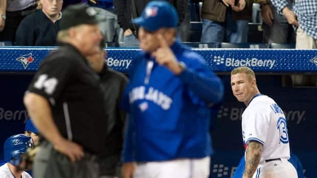 Toronto Blue Jays Brett Lawrie (right) looks back after being ejected from the game after contesting a strike out call, as Home Plate Umpire Bill Miller (left) is confronted by Jays Manager John Farrell during the ninth inning against Tampa Bay Rays in Toronto on Tuesday.