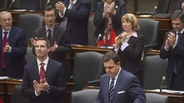 Members of the Ontario government applaud Finance Minister Dwight Duncan, seen at bottom right, as he prepares to deliver his 2012 Ontario budget at Queen's Park.