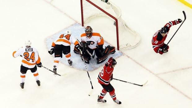 New Jersey Devils' Zach Parise (9) and Travis Zajac (19) celebrate scoring against Philadelphia Flyers goalie Ilya Bryzgalov (30) in the first period of Game 3 on Thursday.