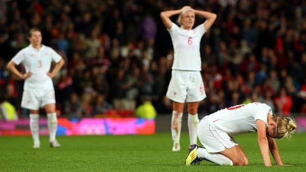 Canadian players react after the final whistle after losing 4-3 in their women's soccer semifinal match Monday against the United States.