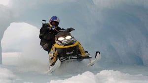 Snowmobiler riding in snow