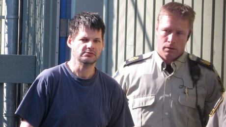 Randall Hopley, left, is led out of the Cranbrook, B.C. courthouse on Sept. 14, 2011. Hopley has been declared a long-term offender and faces a prison term with a period of supervision after his release. THE CANADIAN PRESS/Bill Graveland hi-bc-110914-randall-hopley-cp