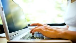 Hands typing on computer