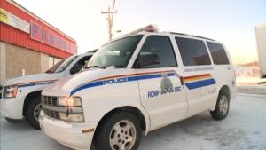 RCMP vans parked in front of Warr's Pharmacy