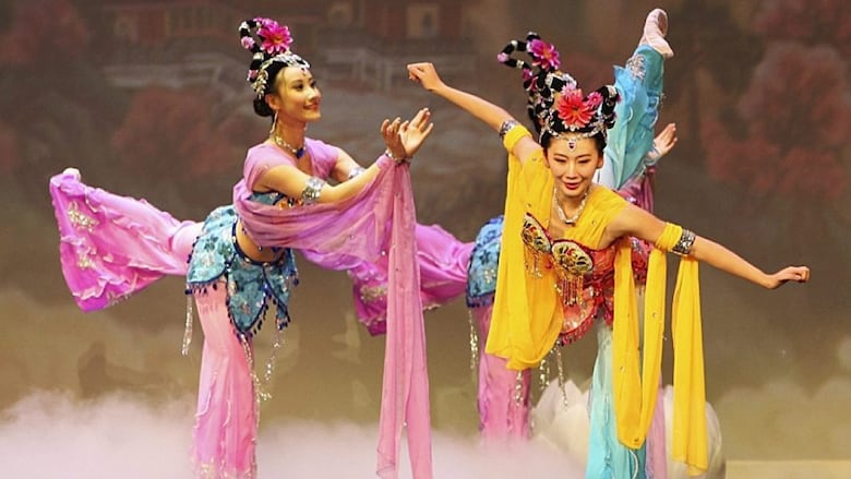 Dancers perform in brightly coloured costumes.