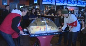 Trevor Linden plays bubble hockey