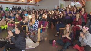 Students at Quest University watch women's half pipe