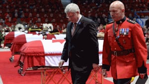 Prime Minister Stephen Harper and RCMP Commissioner Bob Paulson at funeral for Moncton Mounties