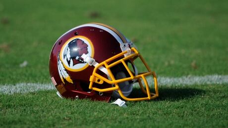 A Washington Redskins football helmet lies on the field during NFL football minicamp, Wednesday, June 18, 2014, in Ashburn, Va. The U.S. Patent Office ruled Wednesday, June 18, 2014, that the Washington Redskins nickname is "disparaging of Native Americans" and that the team's federal trademarks for the name must be canceled. The ruling comes after a campaign to change the name has gained momentum over the past year. (AP Photo/Nick Wass) Redskins Name Football