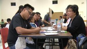 Filipinos getting passports renewed in Regina skpic