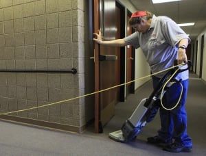 A woman vacuums a building in Rapid City, S.D.