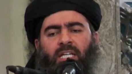 This image made from video posted on a militant website Saturday, July 5, 2014, which has been authenticated based on its contents and other AP reporting, purports to show the leader of the Islamic State group, Abu Bakr al-Baghdadi, delivering a sermon at a mosque in Iraq. A video posted online Saturday purports to show the leader of the Islamic State extremist group that has overrun much of Syria and Iraq delivering a sermon at a mosque in Iraq, in what would be a rare - if not the first - public appearance by the shadowy militant. (AP Photo/Militant video) Mideast Iraq