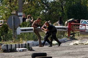 Ukraine crisis servicemen kick Russian activist
