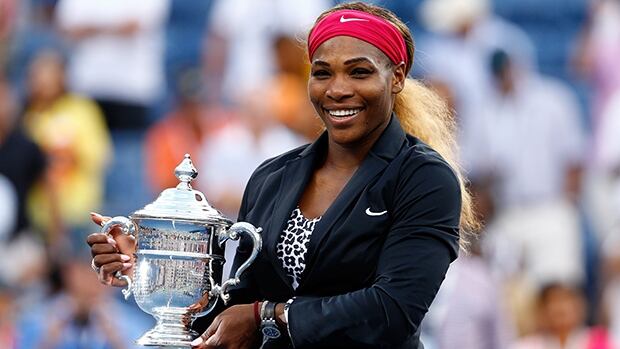NEW YORK, NY - SEPTEMBER 07: Serena Williams of the United States celebrates with the trophy after defeating Caroline Wozniacki of Denmark to win their women's singles final match on Day fourteen of the 2014 US Open at the USTA Billie Jean King National Tennis Center on September 7, 2014 in the Flushing neighborhood of the Queens borough of New York City. Williams defeated Wozniacki in two sets by a score of 6-3, 6-3.