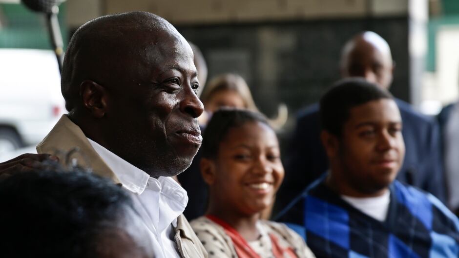 David McCallum, second from left, stands with his immediate family outside Supreme Court on Wednesday Oct. 15, 2014 after a judge exonerated McCallum, and Willie Stuckey, who died in prison, of wrongful imprisonment for murder.