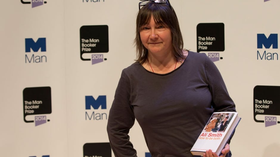 Man Booker prize 2014 nominee British author Ali Smith holds her book 'How to be Both' in London, Monday, Oct. 13, 2014.