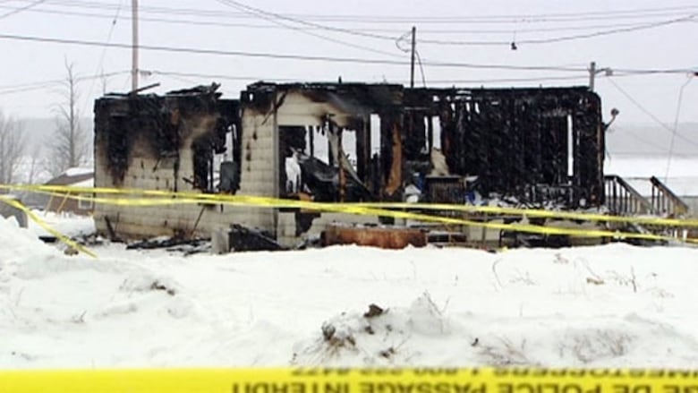 A home badly burned with the roof gone.