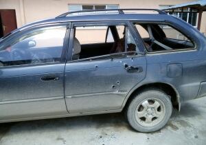 The car riddled with bullet holes
