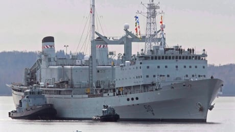 HMCS Preserver is pushed by tugs in Halifax harbour on Oct. 19, 2011. There's a growing divide in the military community about what kind of ships should replace HMCS Preserver and HMCS Protecteur, which are being decommissioned ahead of schedule. Navy Supply Ships