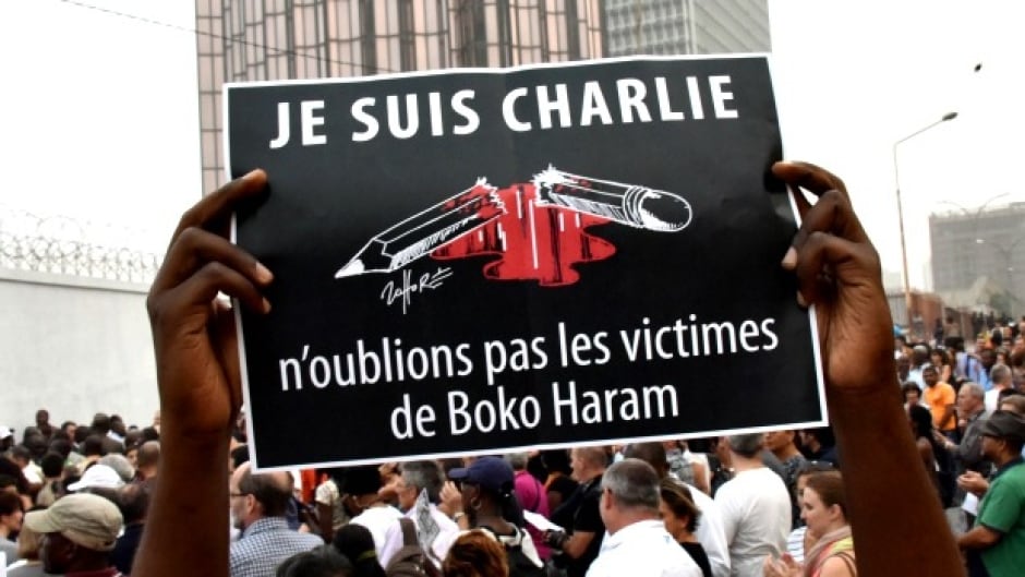 A man holds a placard that reads 'Je suis Charlie, n'oublions pas les victimes de Boko Haram' (I am Charlie, let's not forget the victims of Boko Haram) as people gather outside the French embassy in Abidjan. (Sia Kambou/AFP/Getty Images)