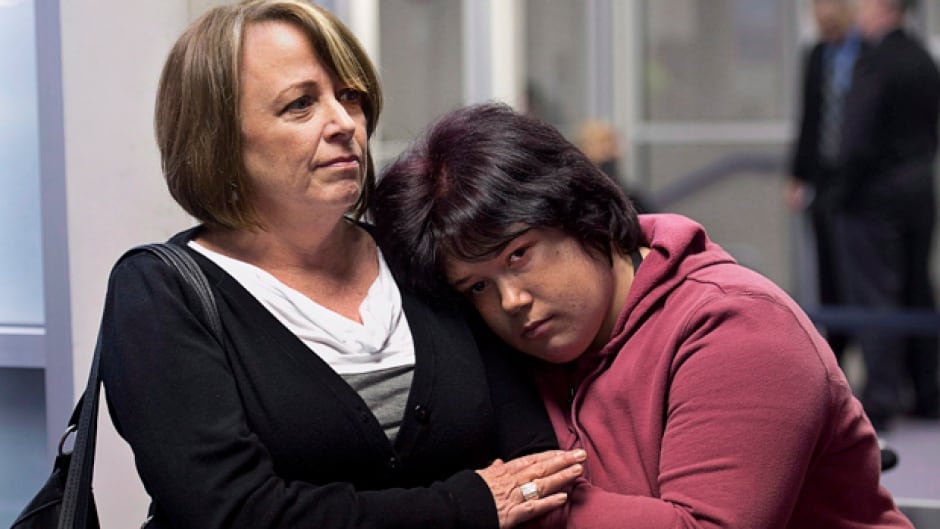 Nichelle Benn, right, and her mother Brenda Hardiman wait at provincial court in Dartmouth, N.S. Benn is facing charges after an incident at the rehabilitation facility where she lives. Hardiman says her daughter's brain disorder causes periodic episodes of aggressive behaviour. (CP/Andrew Vaughan)