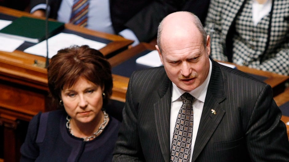 Premier Christy Clark (left) listens as B.C. Finance Minister Mike de Jong tables the provincial budget in the Legislative Assembly Tuesday, February 18, 2014 in Victoria, B.C.
