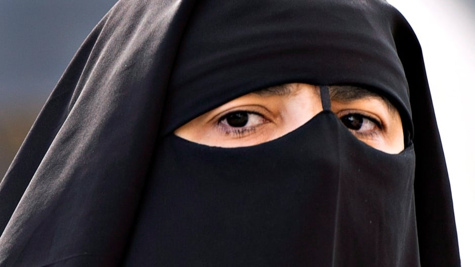 A woman wears a niqab as she walks Monday, September 9, 2013 in Montreal. THE CANADIAN PRESS/Ryan Remiorz
