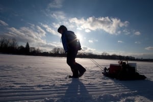 An angler pulls some fishing gear out on the ice